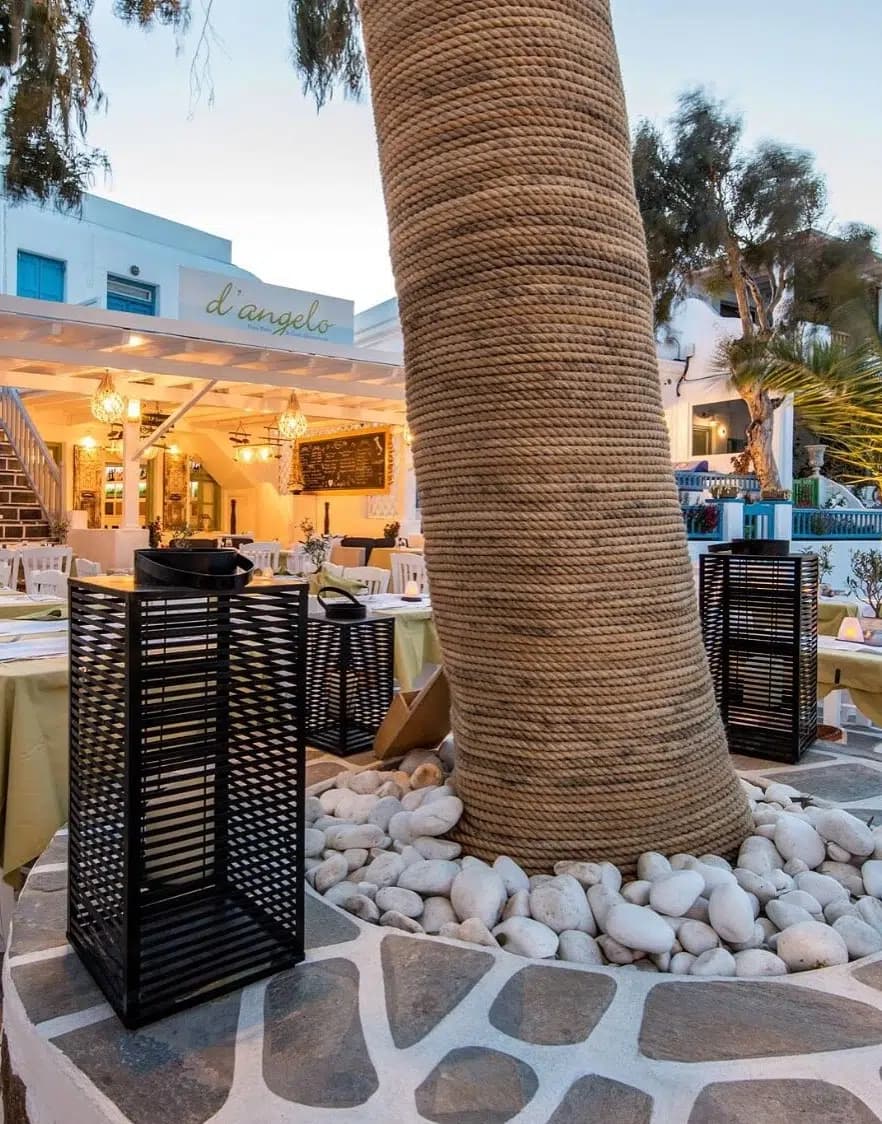 D'Angelo restaurant interior with stone walls, wicker light fixtures, and Mediterranean dining area